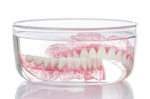 Should You Replace Teeth With Dental Implants or Dentures?